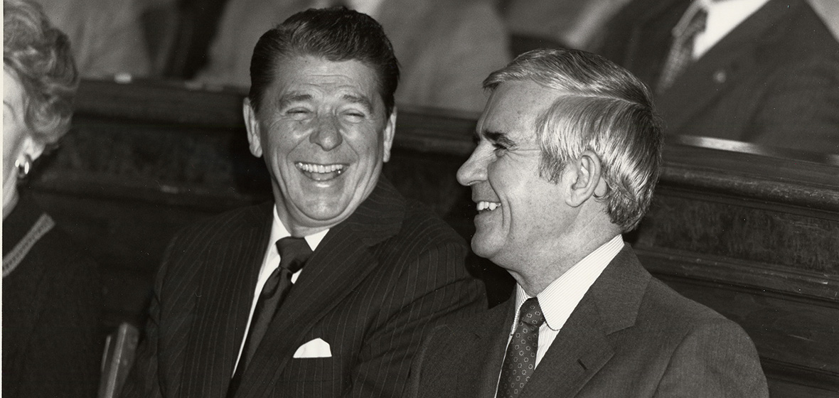 President Ronald Reagan with Paul Laxalt, both wearing suits and laughing