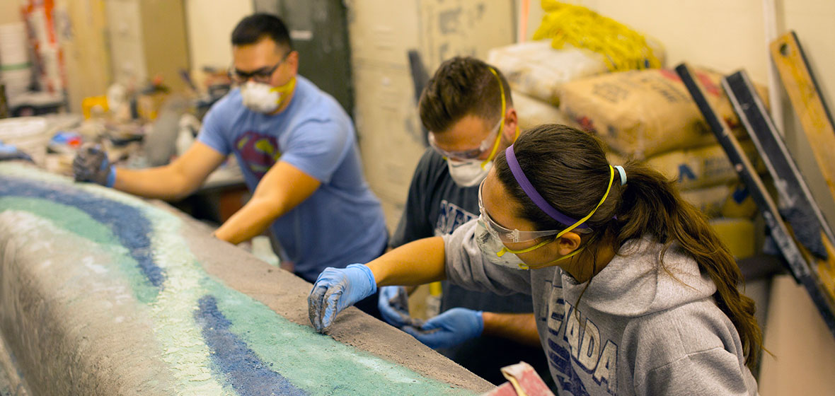 Engineering students work on concrete canoe.