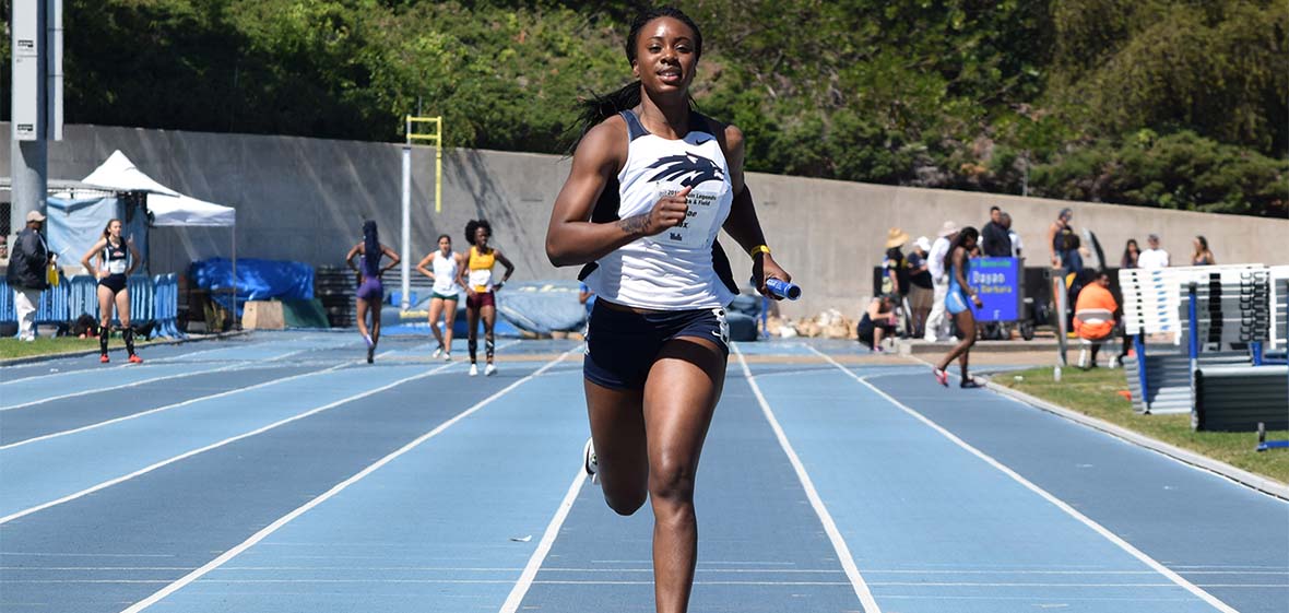 Kashae Knox running with baton 