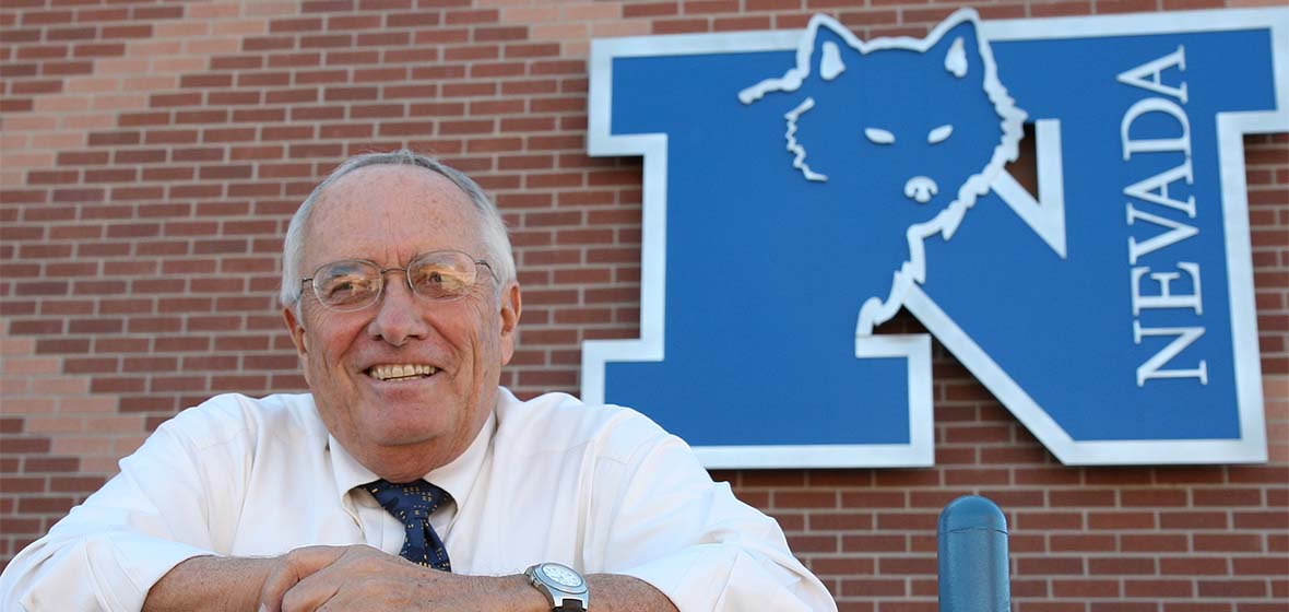 Richard "Dick" Davies standing in front of the Athletics Department at the University of Nevada, Reno