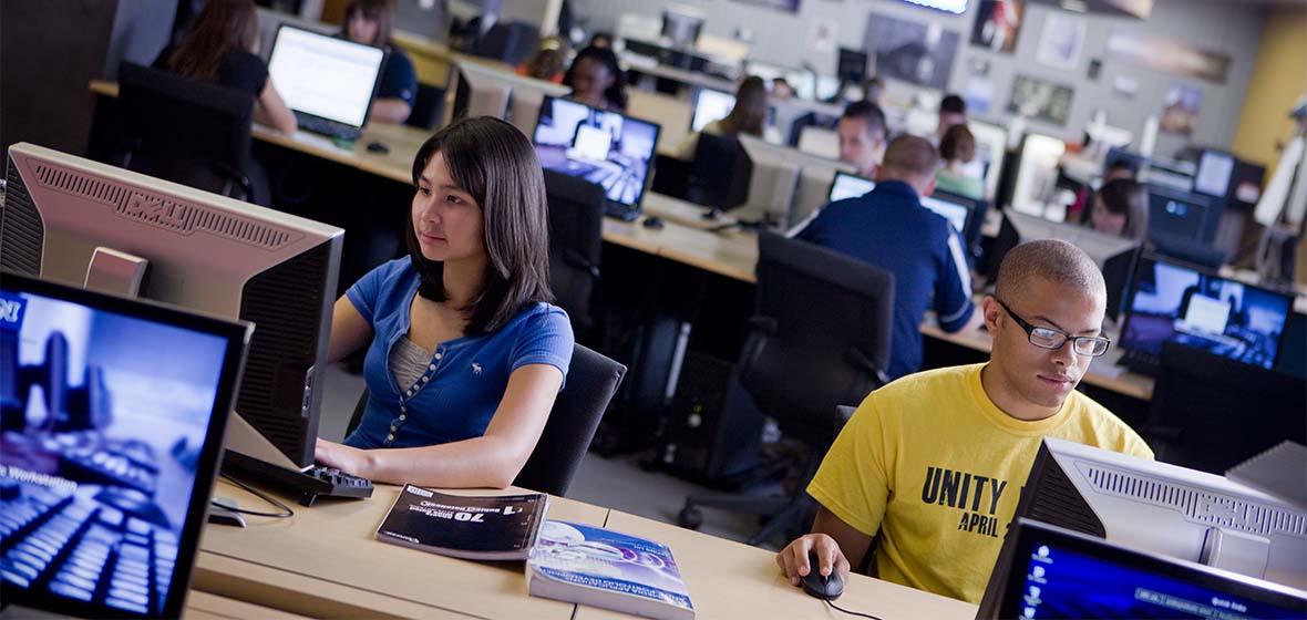 Two students sitting at computers in a University computer lab