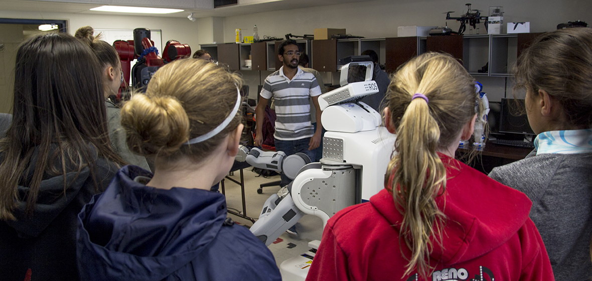 Students are shown how robots work by assistant researcher at the University of Nevada.