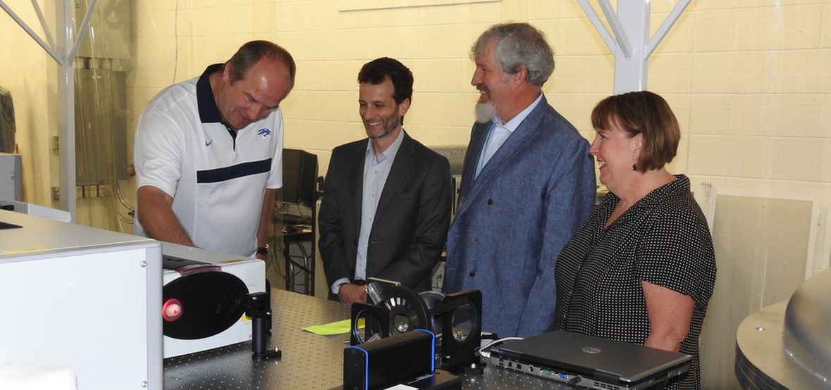 A group of four looks at one of the laser systems at the Nevada Terawatt Facility