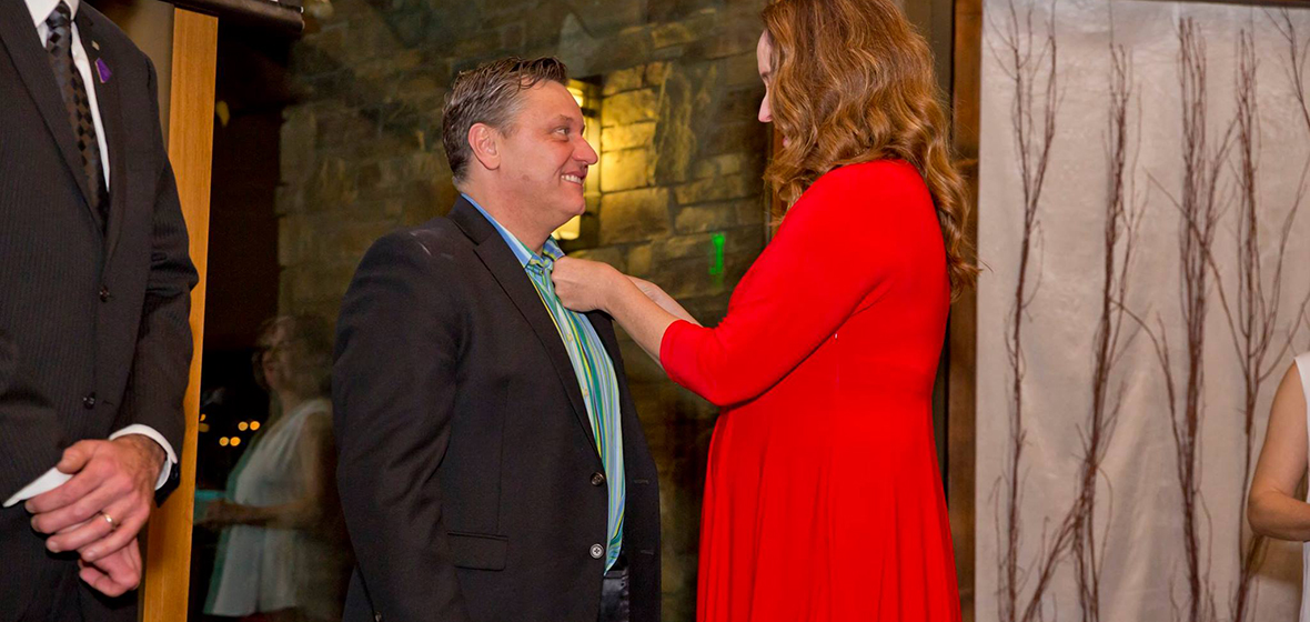 Anne McMillin, APR, pinning one of the newest APR designated professionals Todd Felts, APR. 