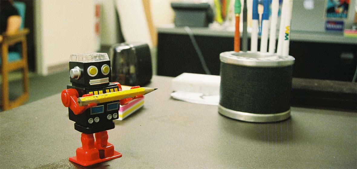 A small robot toy on a table. 