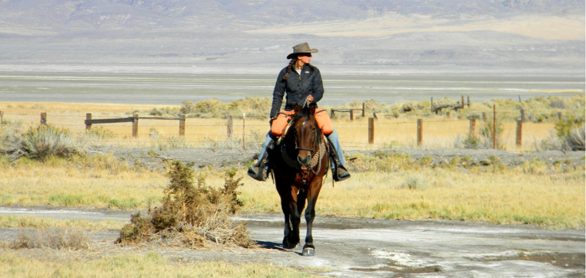 Samantha Szesciorka riding on Sage in the Nevada desert