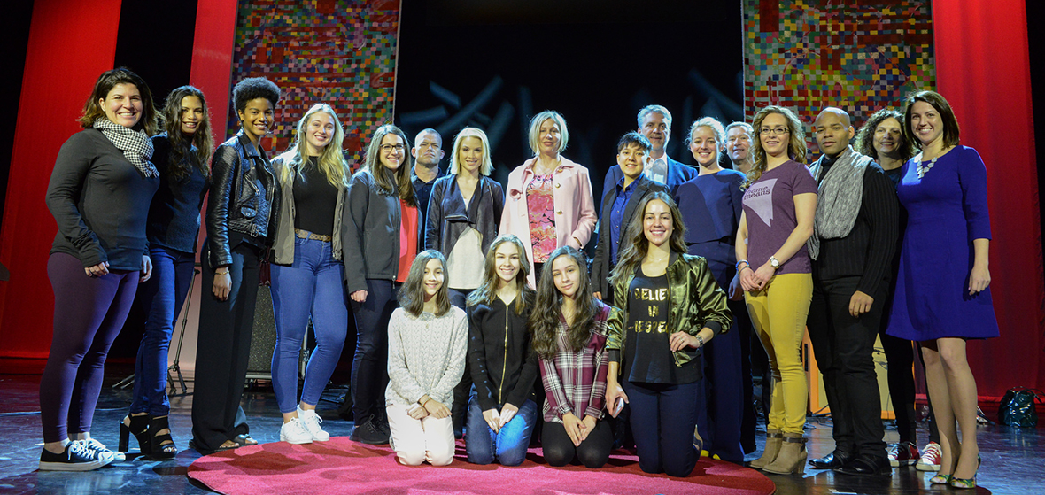 A group of people posing in front of a camera at TEDxUniversityOfNevada event, inside the Grand Sierra Grand Theatre.