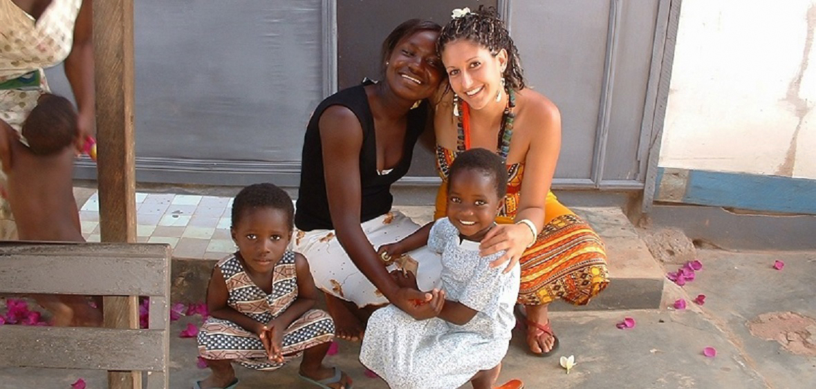 Friendly USAC participant sits with a mother and two children