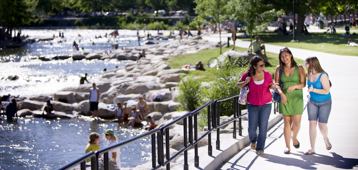 Students walk along the Truckee River downtown.