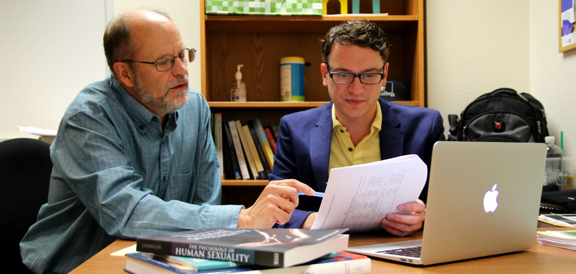 Dan Weigel and Randal Brown looking over reseach in office