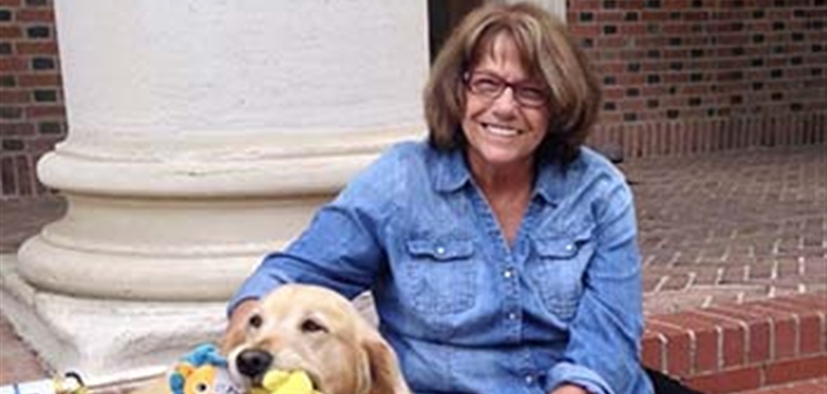 Barbara King and her dog outside of Frandsen Humanities Building