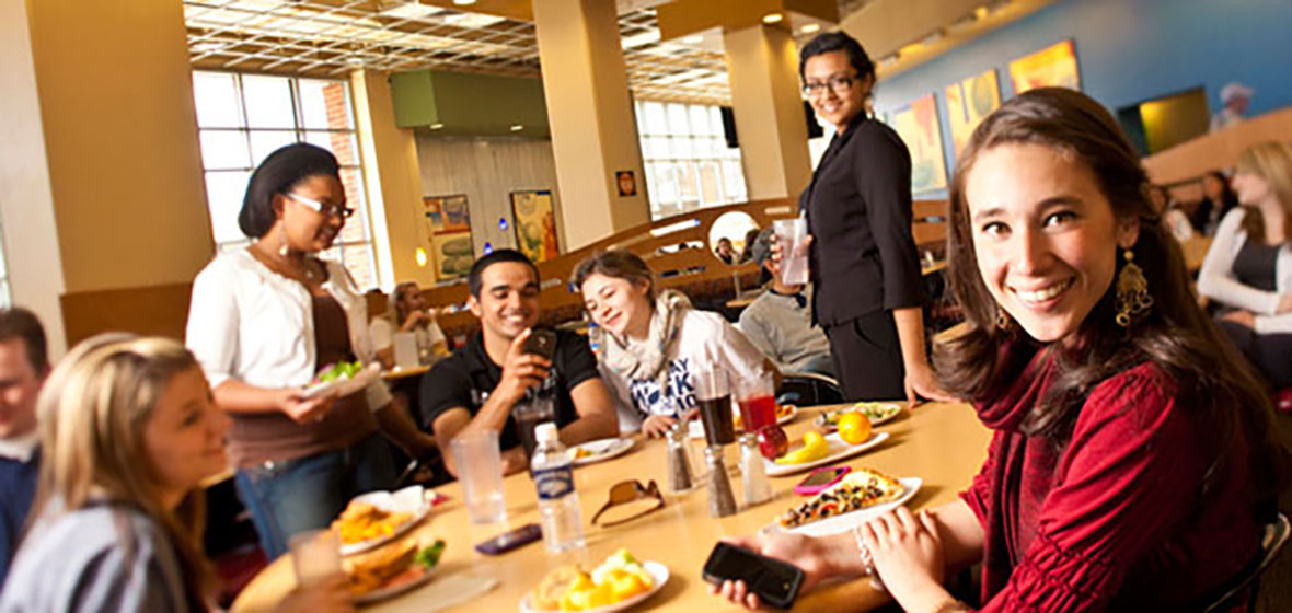 Students are posing in the Downunder Cafe. 