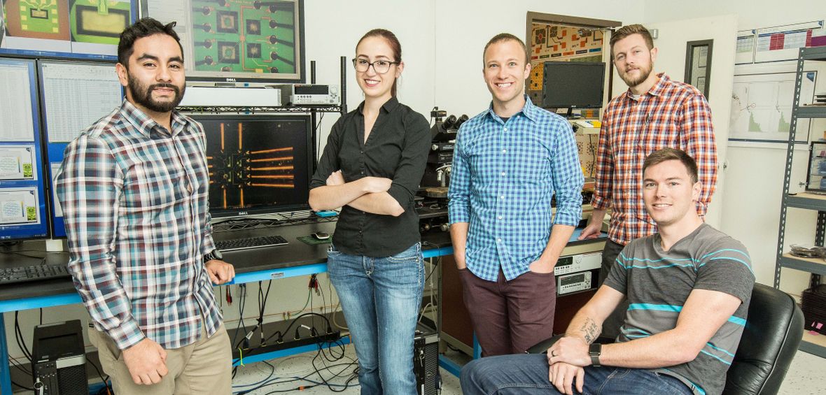 5 University alumni who work at NevadaNano are photographed in a laboratory setting.