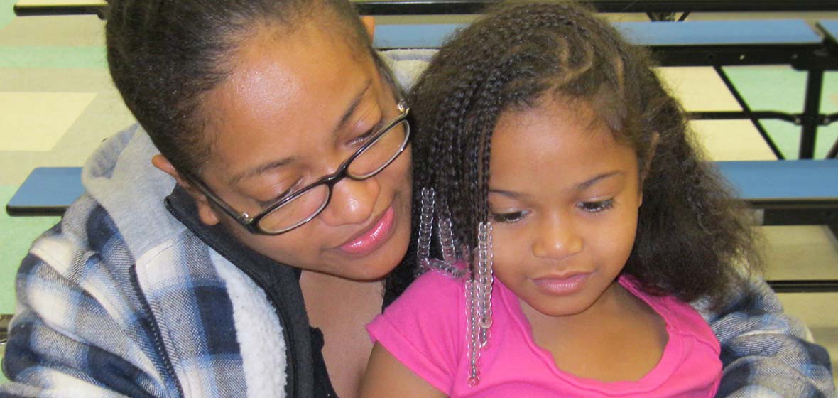 Mom and daughter reading a book together