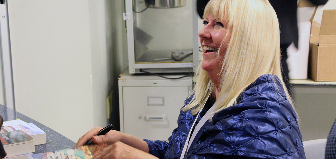 Sally Denton smiles while signing books after her talk. 