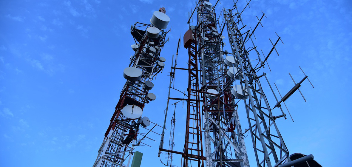 Photo of a radio tower against a blue sky. 