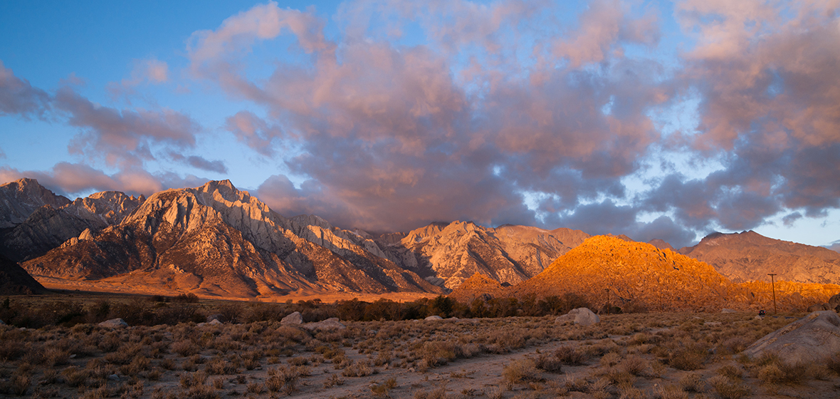 Sierra Nevada mountain range with rural, uninhabited land in the foreground.