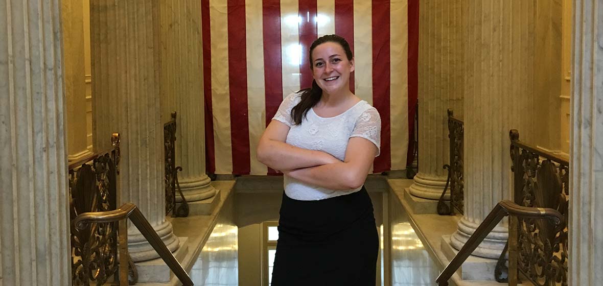 Kate Groesbeck in Washington, D.C. in front of an American flag