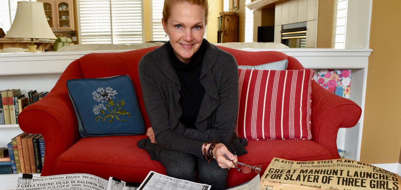 University of Nevada Lecturer Pamela Everett sits with newspapers which covered the murder and manhunt for her aunts in the late 1930s.
