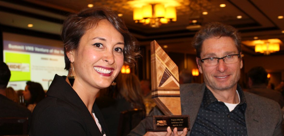 Innevation Center Operations Officer Rosanne Catron holds the award while Innevation Center Director Jim Sacherman looks on.