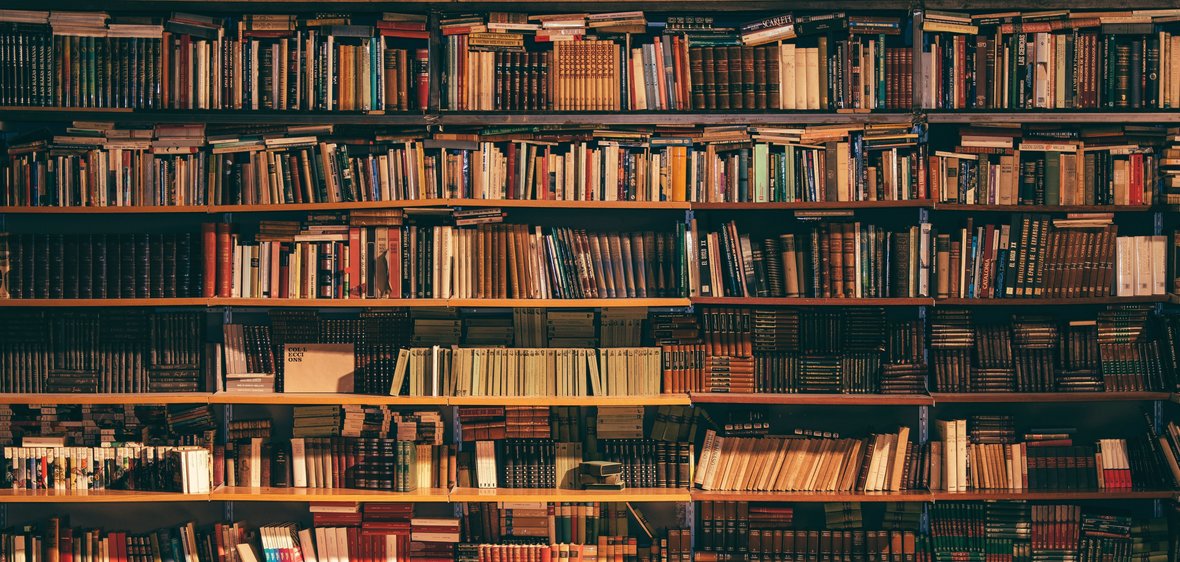 A bookshelf filled to the brim with books