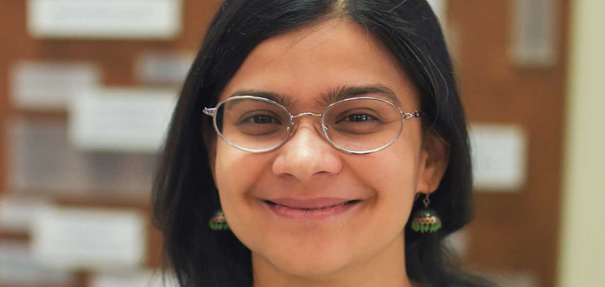 A woman smiles for the camera. 