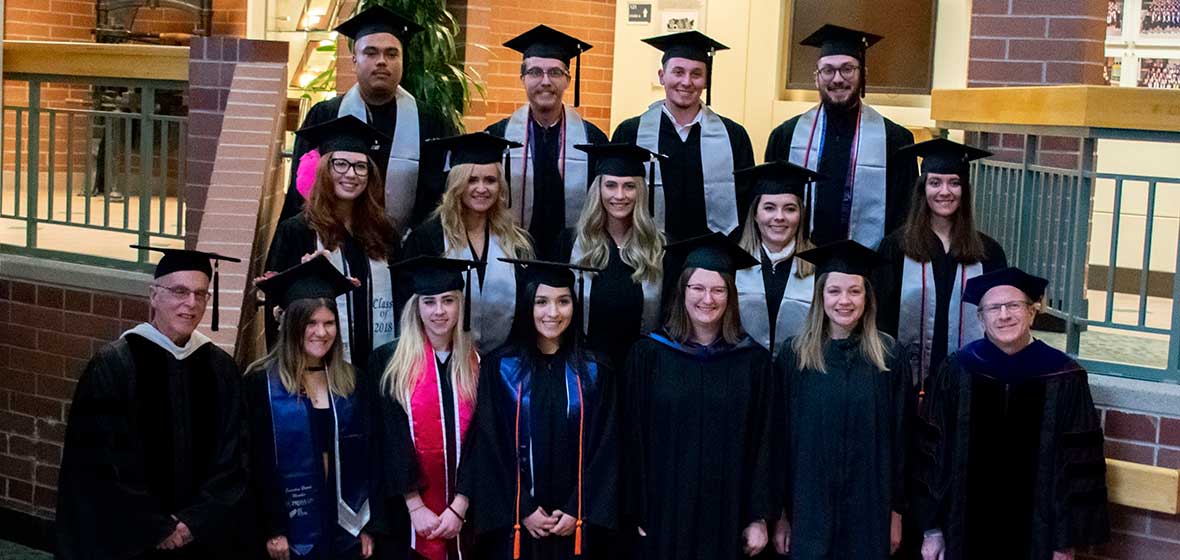 A group of students stand on a set of stairs. 