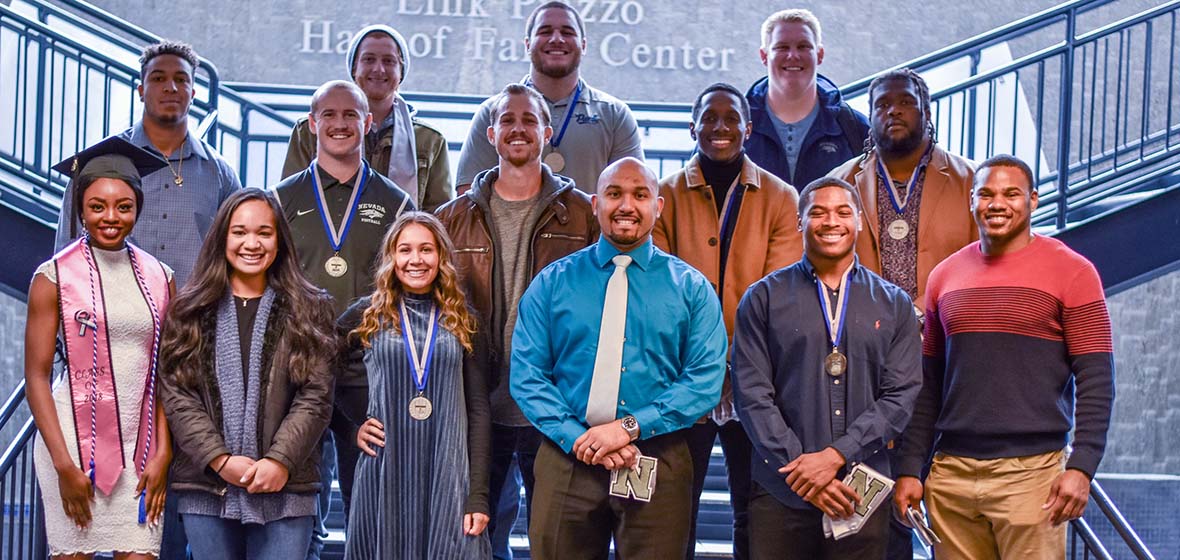 Student athletes who are set to graduate stand together.