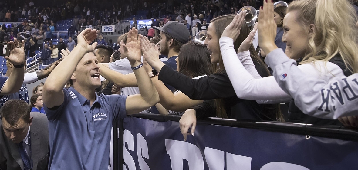 Coach Eric Musselman high fives fans