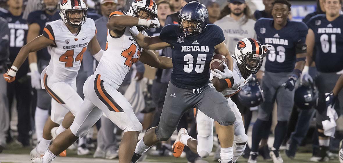 Nevada Wolf Pack Football running back Taua Toa runs past players of the Oregon State Beavers during a game Sept. 15, 2018, played at Mackay Stadium in Reno