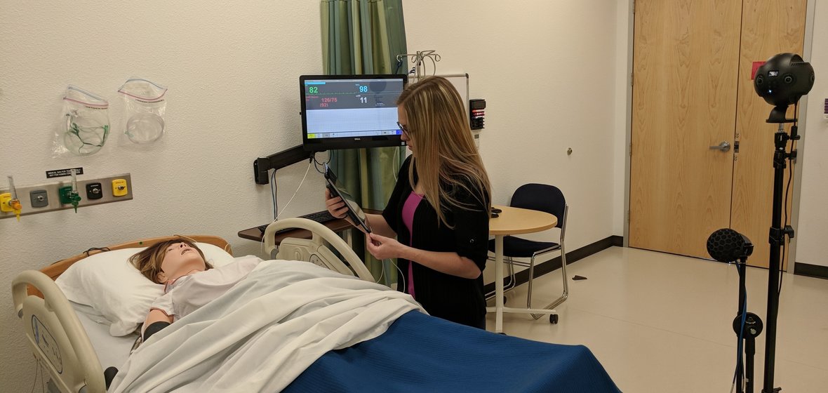 Libraries Multimedia Specialist Michelle Rebaleati works with "SIM Mom" at UNR Med to compose the shot for the 360-degree, 3D virtual reality footage she and colleague Luka Starmer created for the research study