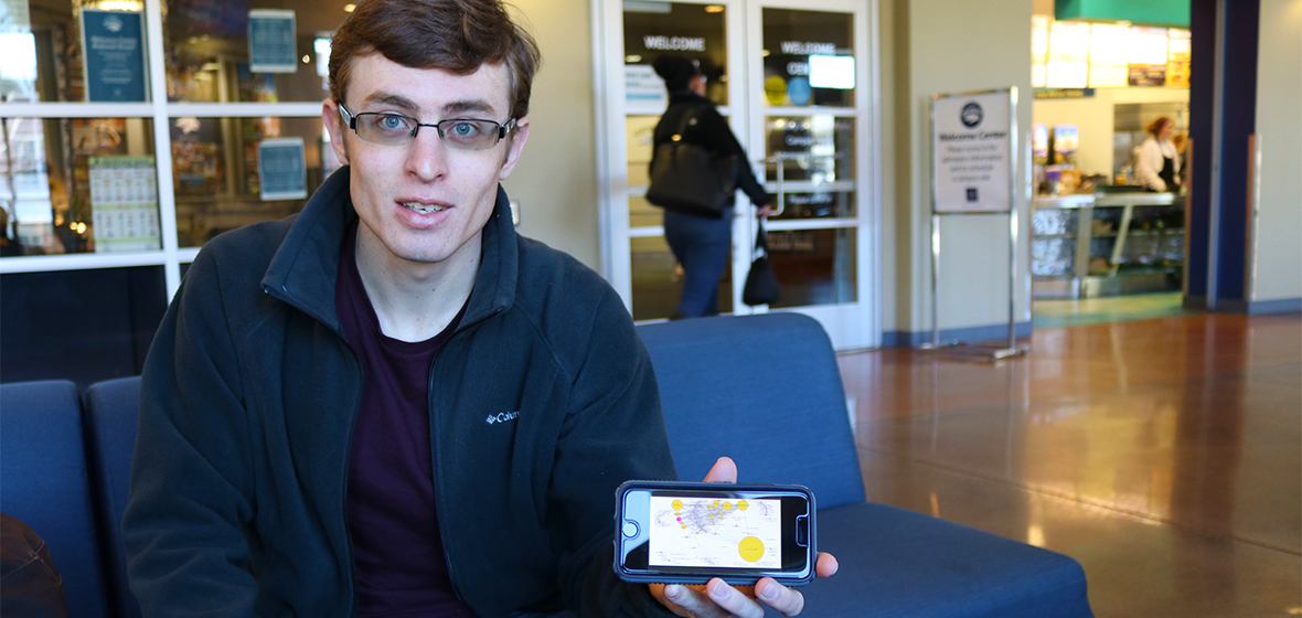 Student Michael Walecke holding photo with picture of data