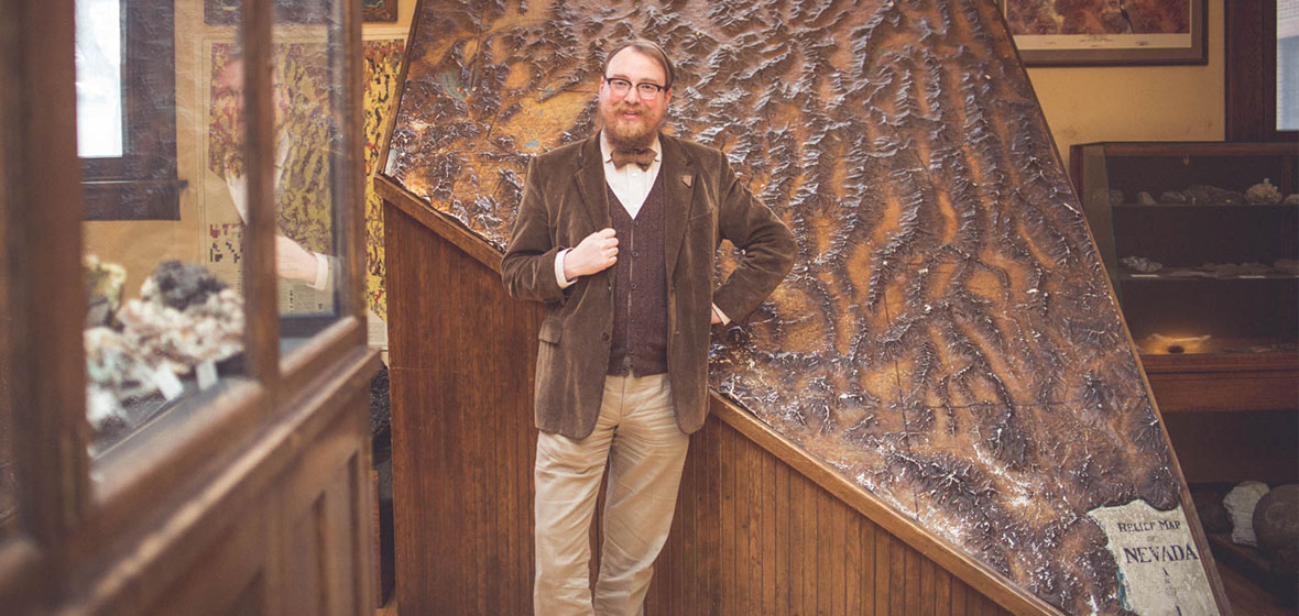 Garrett stands in front of the Nevada relief Map