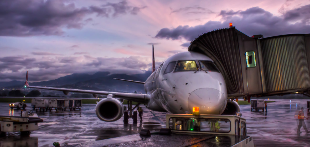 Airplane on tarmac at sunrise