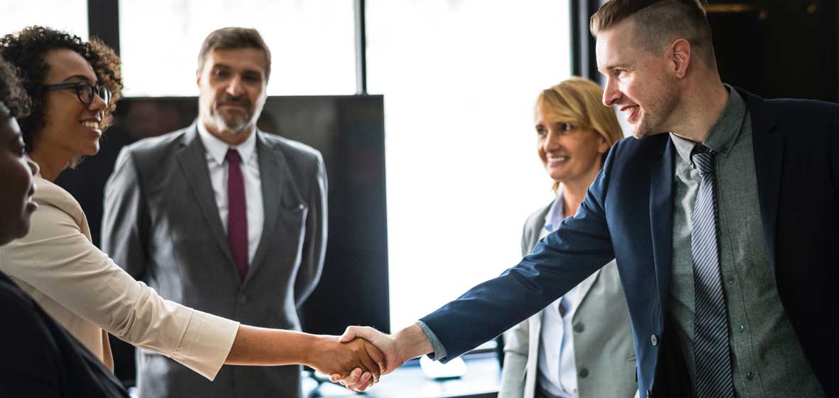 Two people shake hands. 