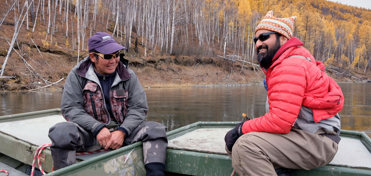 Ganzorig Batsaihan (left) sits with Sudeep Chandra on a river boat