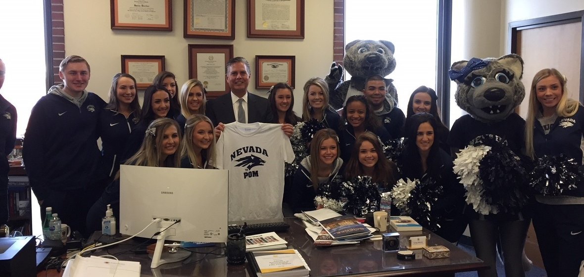 Business Dean Greg Mosier with cheerleading team