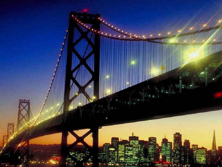 Golden Gate Bridge at night with city lights