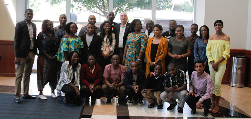 The 2018 Mandela Washington Fellows pose with University President Marc Johnson in the Mathewson-IGT Knowledge Center.