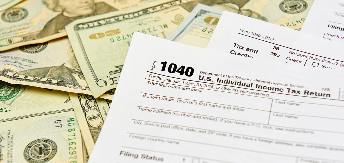 1040 income tax forms and twenty dollar bills
