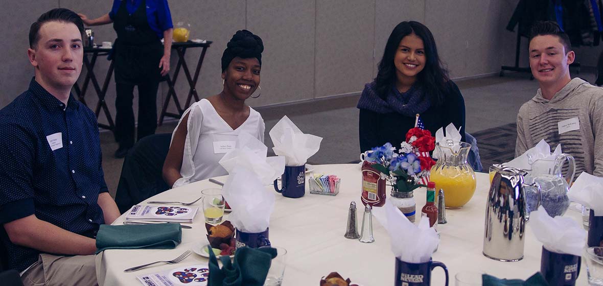 Four students sitting at a table during the 3rd annual Civic Recognition Breakfast on University of Nevada, Reno campus