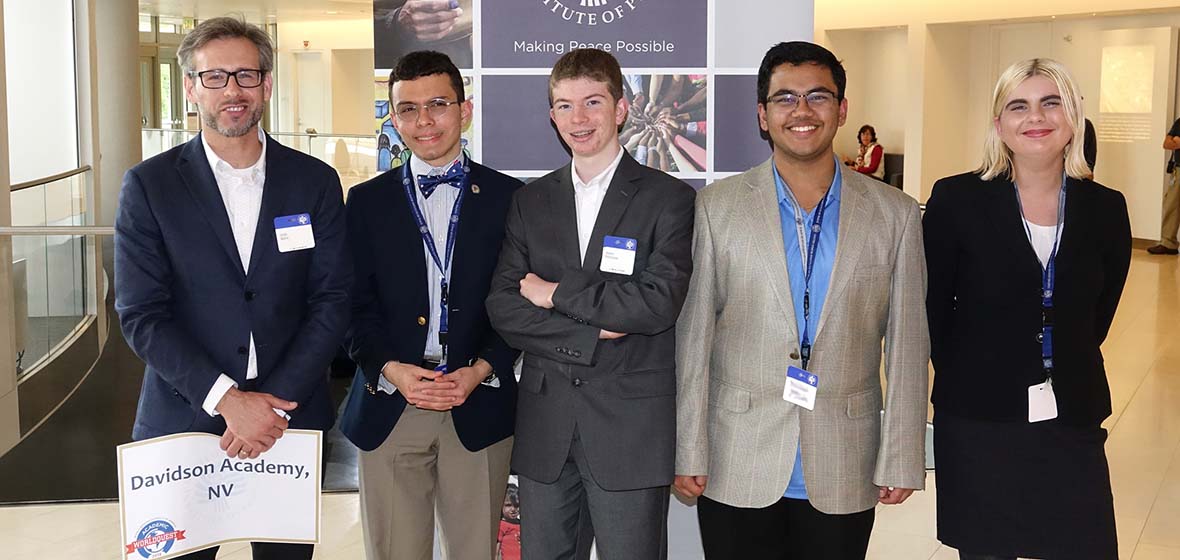 An instructor and four students at the United States Institute of Peace reception for the 2018 national Academic WorldQuest competition