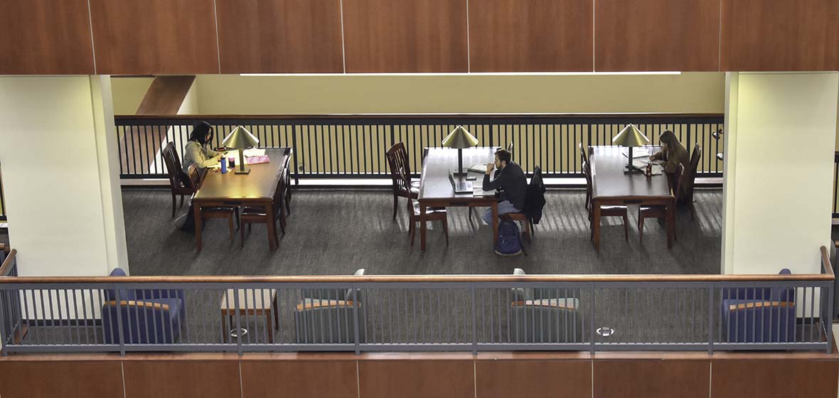 Three table sets of students study in the Mathewson-IGT Knowledge Center at the University of Nevada, Reno