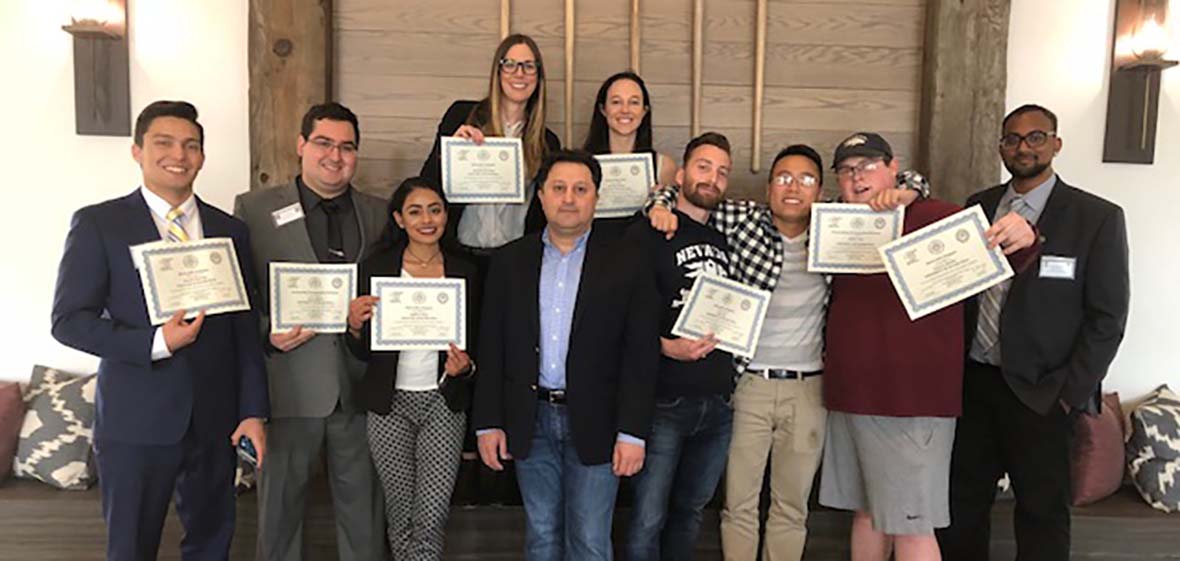 University of Nevada, Reno students pose for a photo each showing their winning certificate after the 2018 Model Arab League competition 