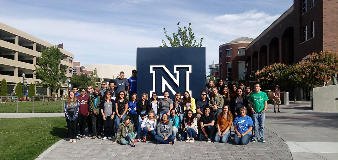 Students from Carson High School's EDUCARSON program, sit in front of the large blue N located outside the University's Mathewson-IGT Knowledge Center.