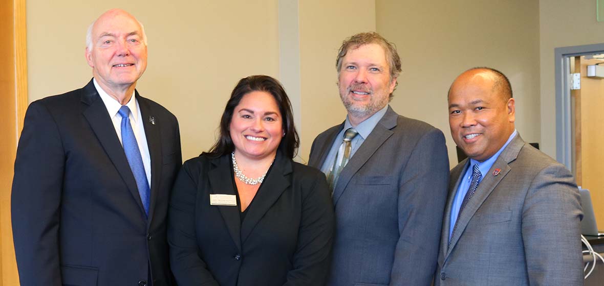 Four Judicial Epicenter parters stand and pose for a photo