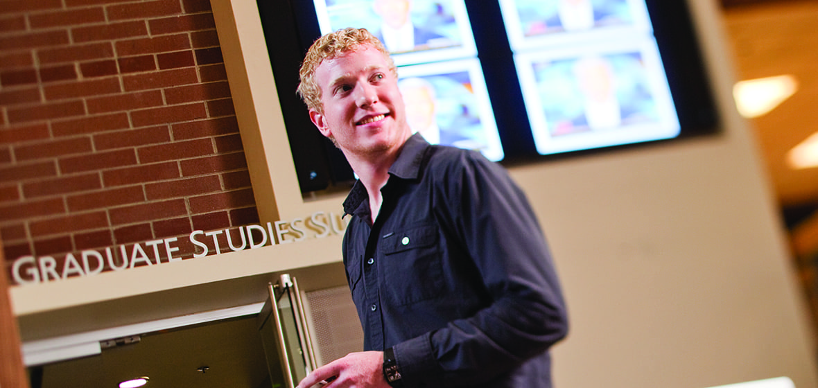 Student stands inside the Reynolds School