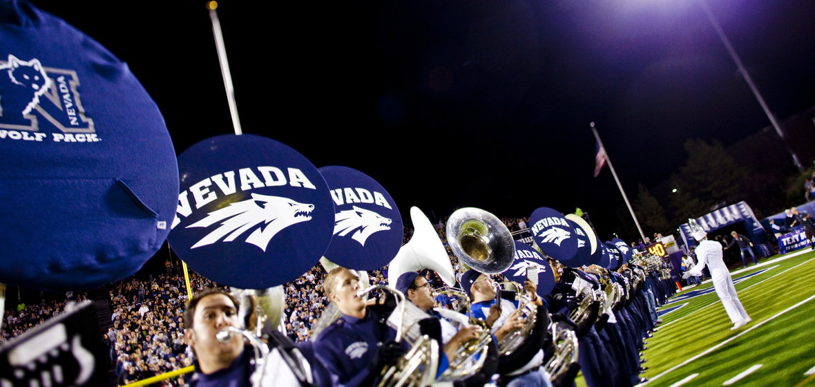 Members of the Nevada Marching Band in a line of Sousaphones.
