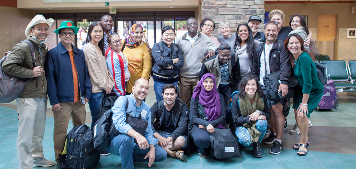 A group of international teachers poses for a photo at the Reno-Tahoe airport.