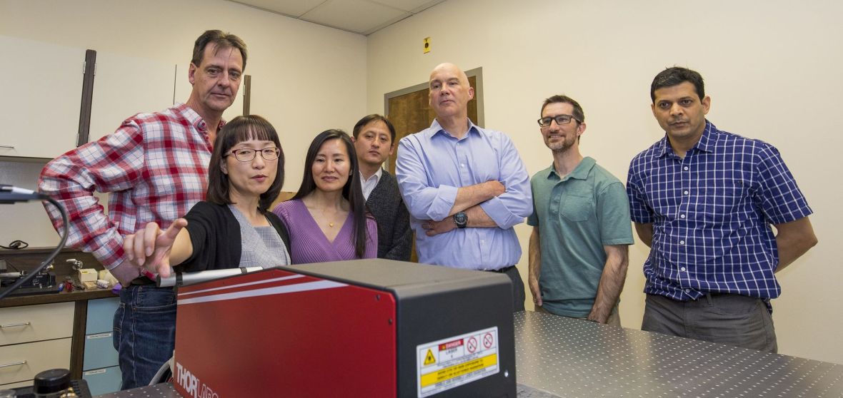 Seven faculty members view demonstration of a large-size "two-photon" microscope